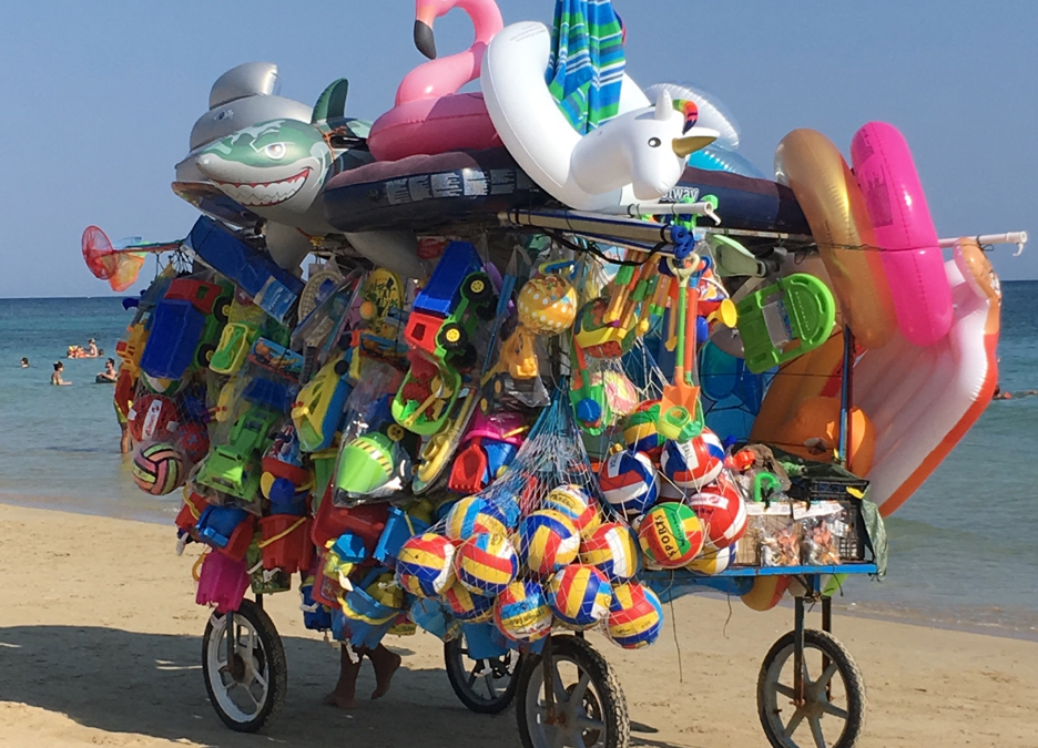Beach toy salesman pulling his cart